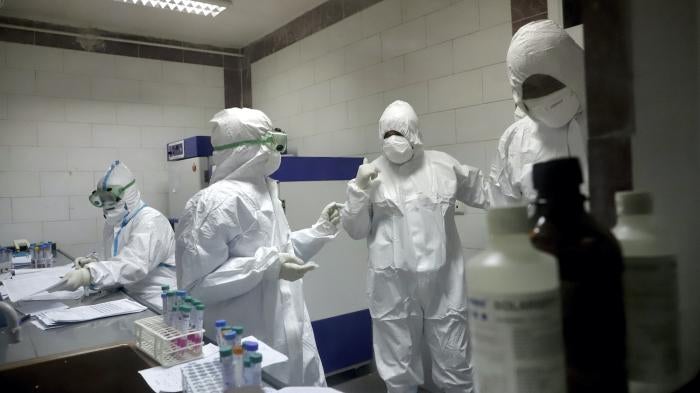 Paramedics work in a laboratory that tests samples taken from patients suspected of being infected with the new coronavirus, in the southwestern city of Ahvaz, Iran, March, 10, 2020.