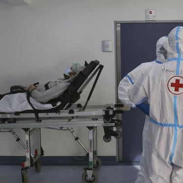 Red Cross volunteers waiting with a coronavirus patient for a place in the intensive care unit of Rafic Hariri University Hospital, Beirut, January 11, 2021.