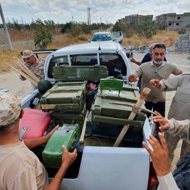 Libyan deminers stand around a pickup truck with boxes of dismantled mines and remnants of other explosives in Salah al-Din, south of the Libyan capital, Tripoli, June 15, 2020. ​​​​​​​