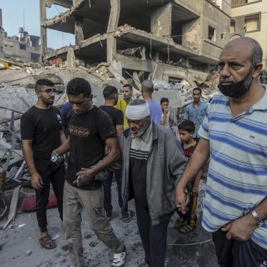 Palestinians help an injured older man following overnight Israeli air strikes on the Rafah refugee camp in Gaza, October 25, 2023.