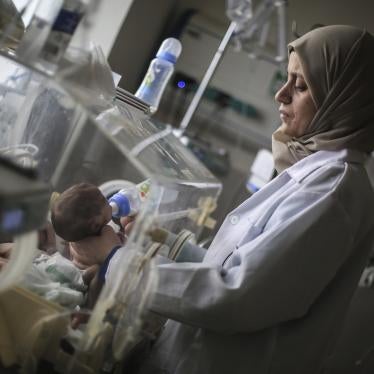 A Palestinian doctor in a hospital in Rafah in the southern Gaza Strip prepares a premature baby to be transferred to Egypt to receive proper medical care, November 20, 2023. 