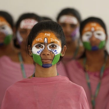 School teachers with the colors of the Indian national flag painted on their faces participate in an event to raise awareness among people to vote in the upcoming general elections