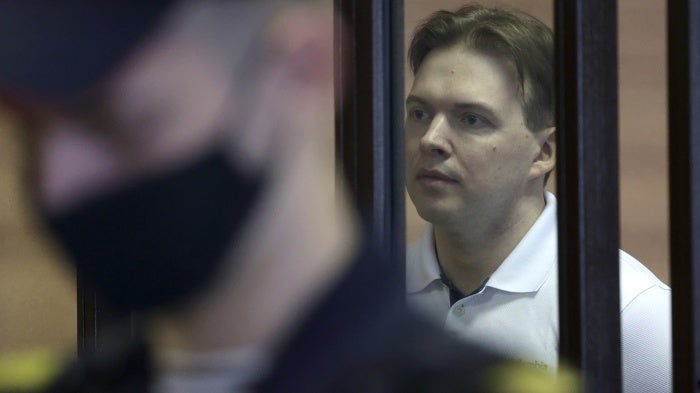 A man is shown behind bars in a courtroom