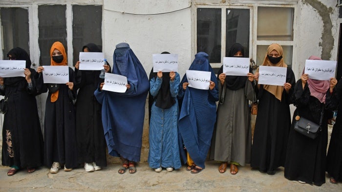 Afghan women hold placards demanding their right to education, in Mazar-i-Sharif on June 26, 2023. 