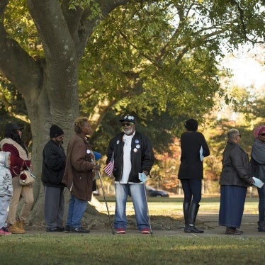 People stand in line to vote