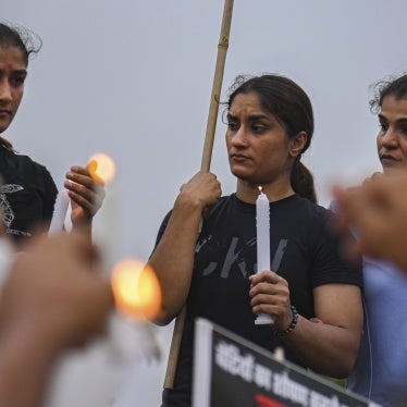 3 women holding candles