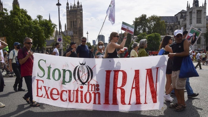 Protesters hold a banner reading 'Stop execution in Iran' during a march in Parliament Square, London, September 16, 2023. 