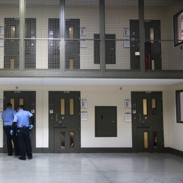 Guards prepare to escort an immigrant detainee from his 'segregation cell' back into the general population at the Adelanto Detention Facility, Adelanto, California, on November 15, 2013. 