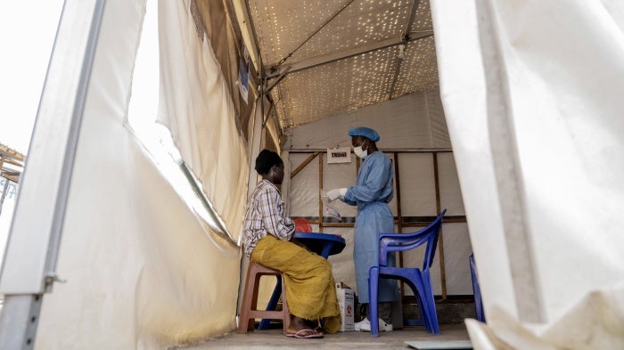 A health worker attends to an mpox patient at a treatment center in Munigi, eastern Democratic Republic of Congo, August 19, 2024. 