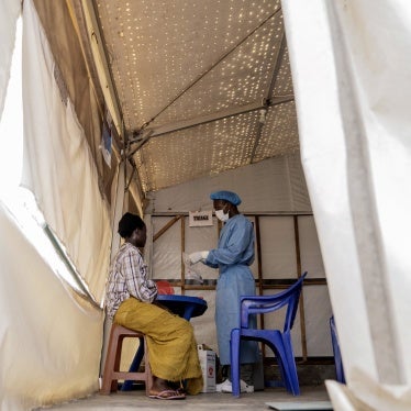 A health worker attends to an mpox patient at a treatment center in Munigi, eastern Democratic Republic of Congo, August 19, 2024. 