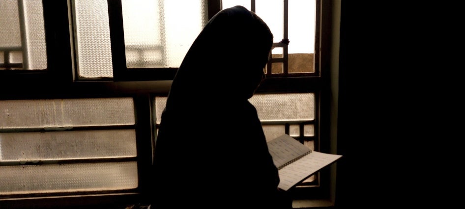 A 15-year-old girl, barred from attending secondary school since 2021, reads a notebook in Afghanistan, March 20, 2024. 