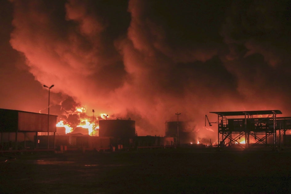 Oil tanks burn following an Israeli strike at the port in Hodeidah, Yemen, July 20, 2024. 