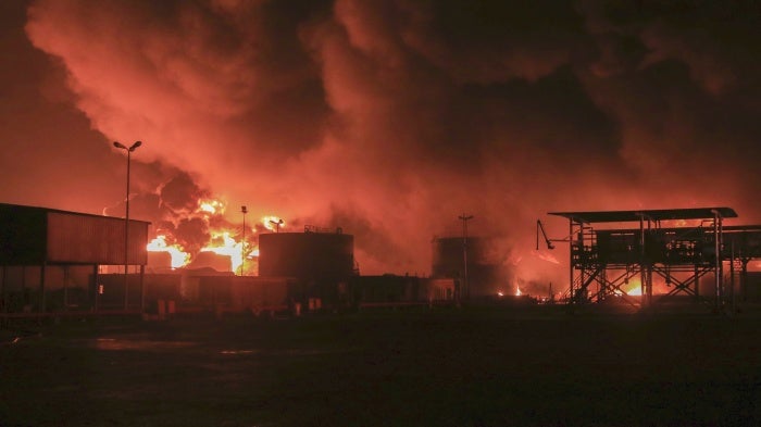 Oil tanks burn following an Israeli strike at the port in Hodeidah, Yemen, July 20, 2024. 