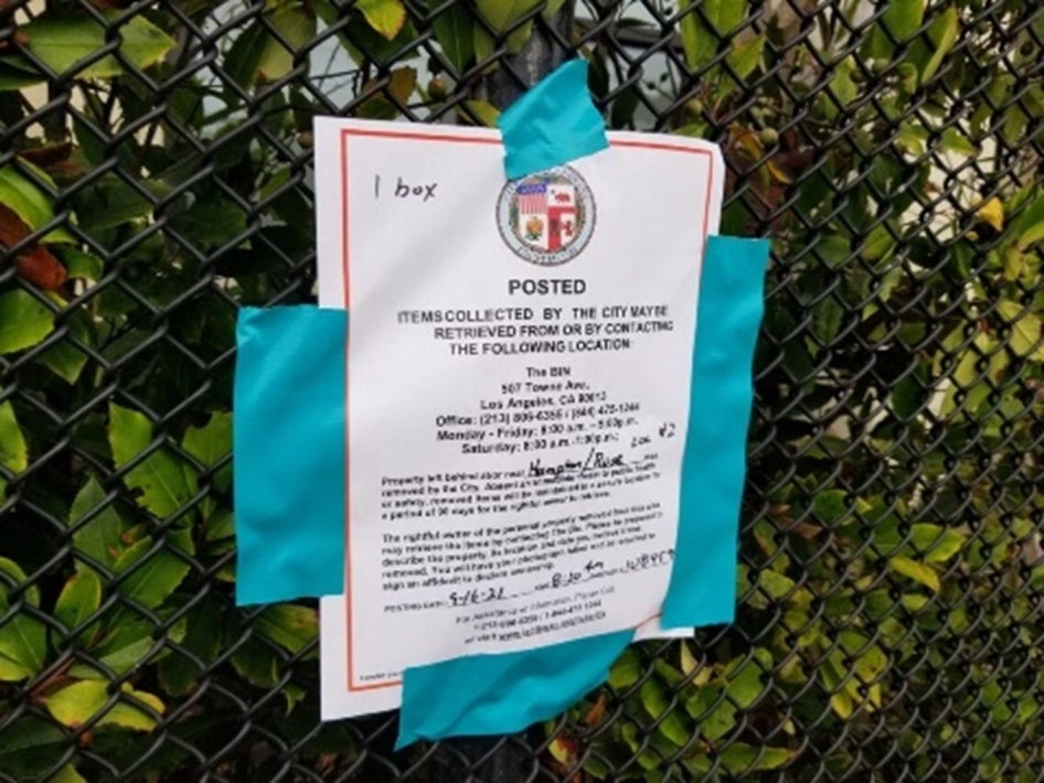 An official notice taped to a fence