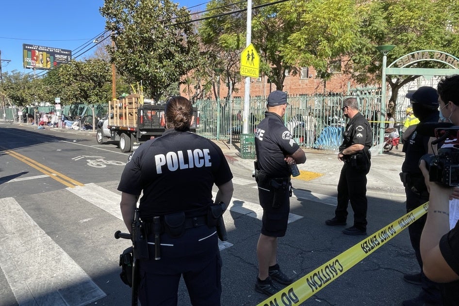 Police stand guard at a perimeter