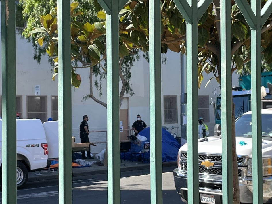 Police seen next to a tent encampment